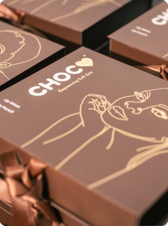 CHOC gift boxes flat-lay with ribbon and line-art illustration