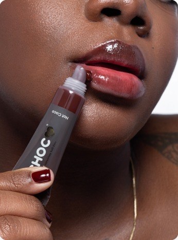 Close-up of CHOC lip gloss applicator on model's lips