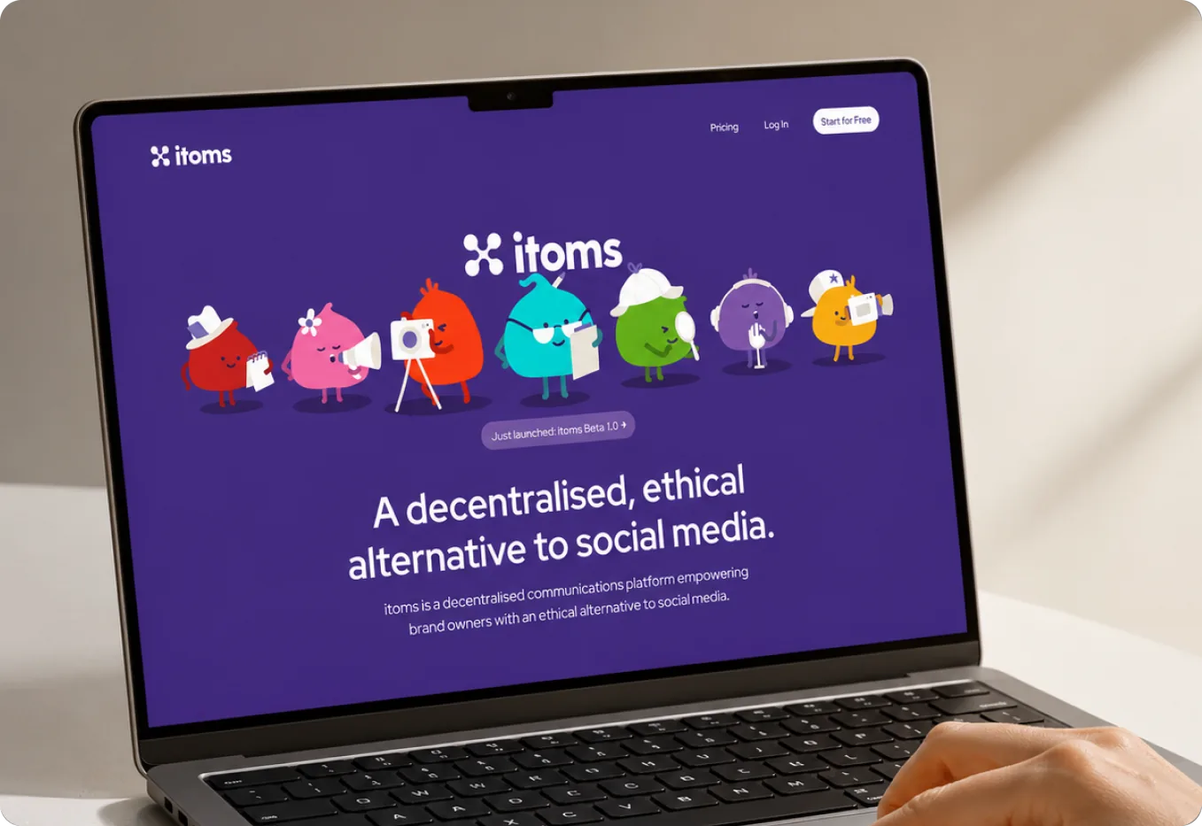 A laptop showing the itoms landing page with the full character line-up across the hero