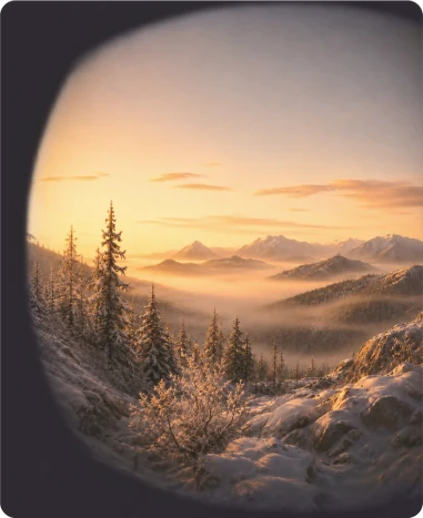 A sunrise over a mountain range seen through the headset's circular lens
